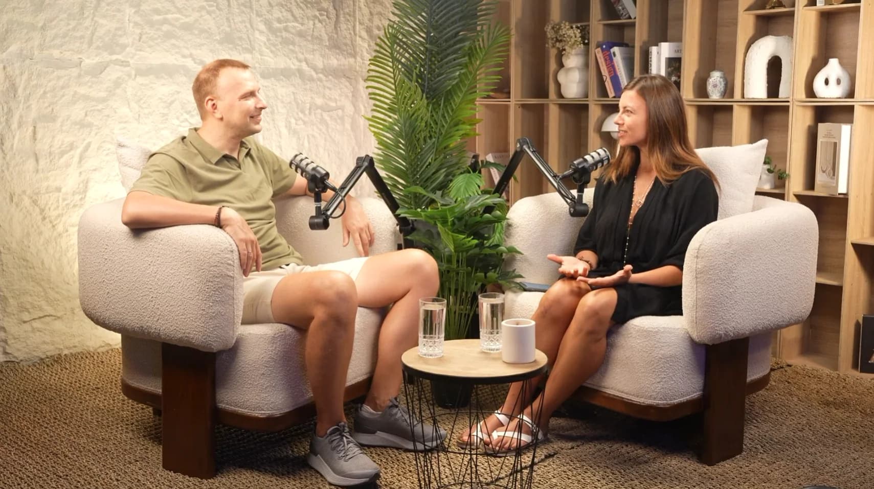 Two-person podcast in a bright armchair studio set