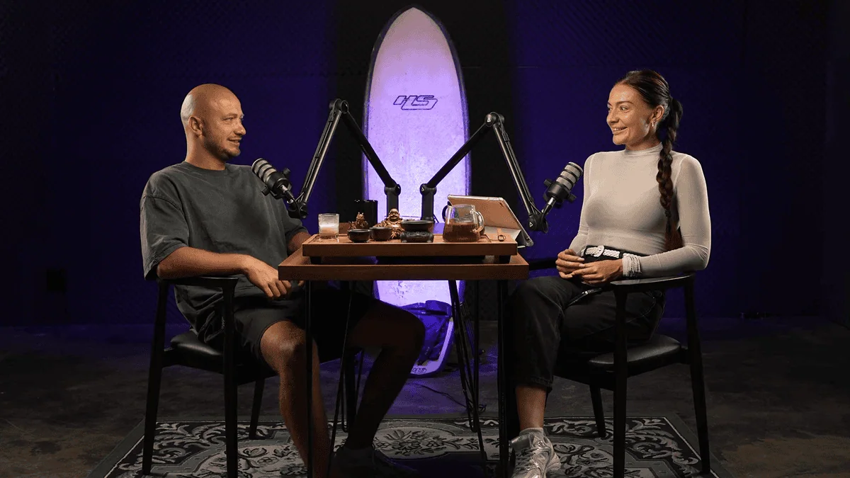 Bespoke podcast studio setup with two hosts, microphones, and modern soundproofing in a stylish environment.
