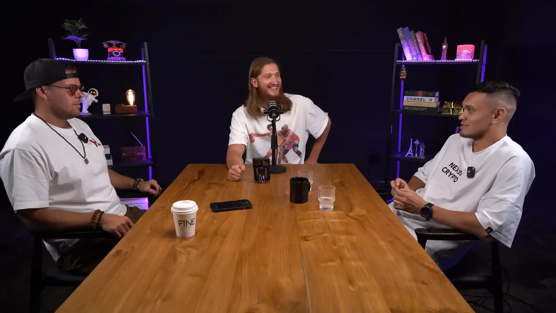 Professional podcast studio featuring hosts discussing topics at Villo Studio, modern setup, vibrant lighting, and stylish decor for content creation.