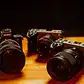 High-quality DSLR cameras on a wooden table in Villo Studio, showcasing professional photography equipment.