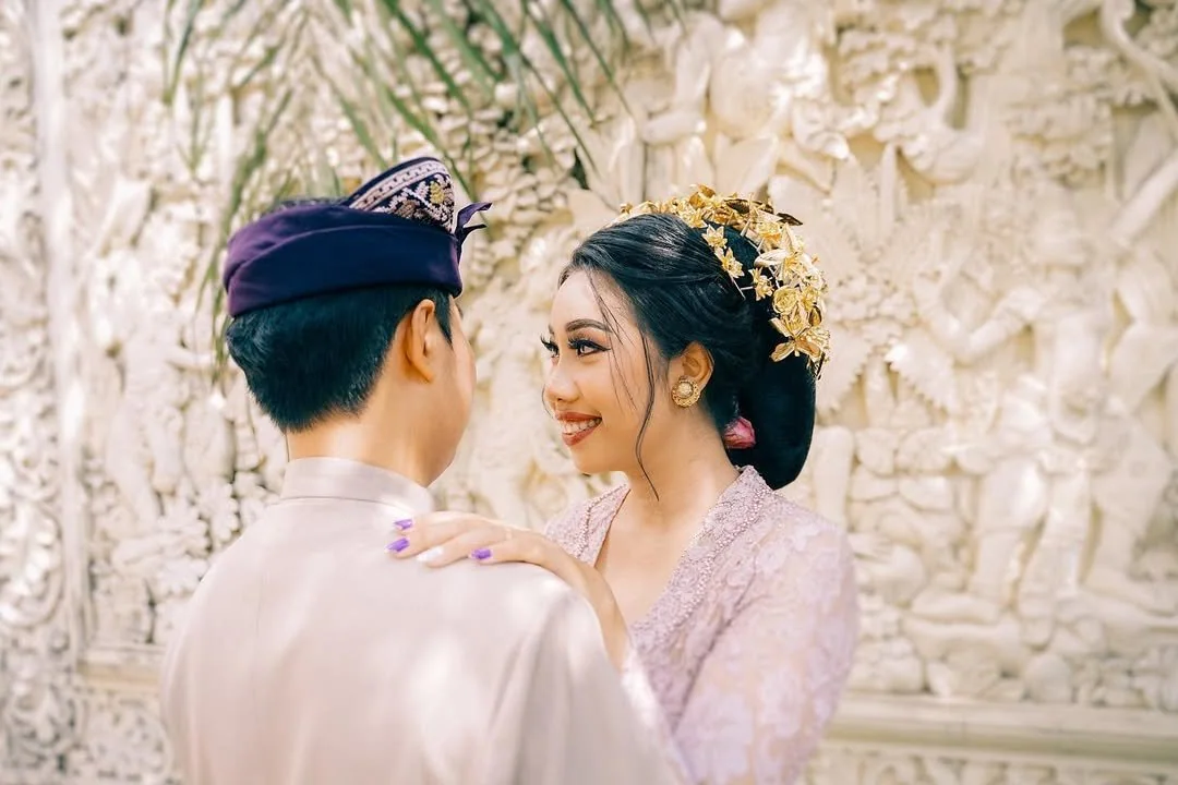 Bride smiling at her groom in traditional Balinese wedding dress