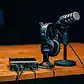 Microphone setup on a wooden desk at Villo Studio, perfect for podcasting and recording sessions.
