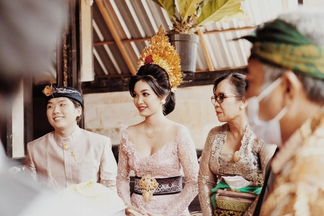 Bride standing with family members during a traditional wedding ceremony