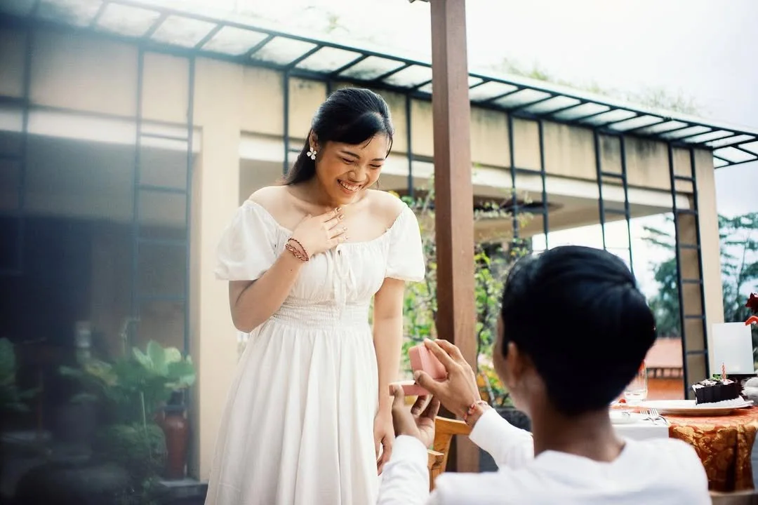 Bride smiling as the groom holds her hand during the ceremony