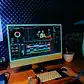 Modern graphic design workspace with computer monitor displaying vibrant digital artwork.