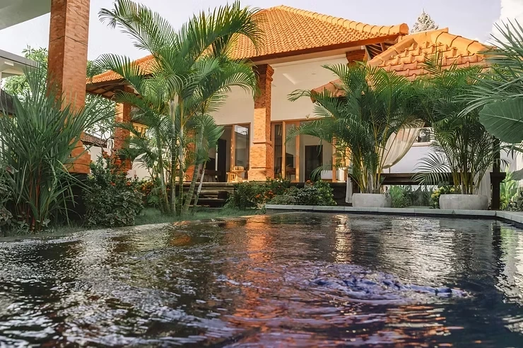 Tropical villa with a courtyard pool and palm trees