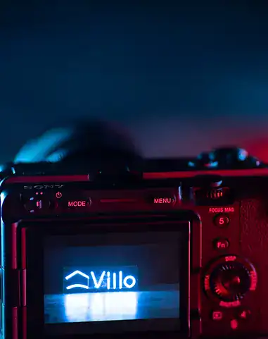 High-quality digital camera displaying Villo Studio logo in low light conditions.