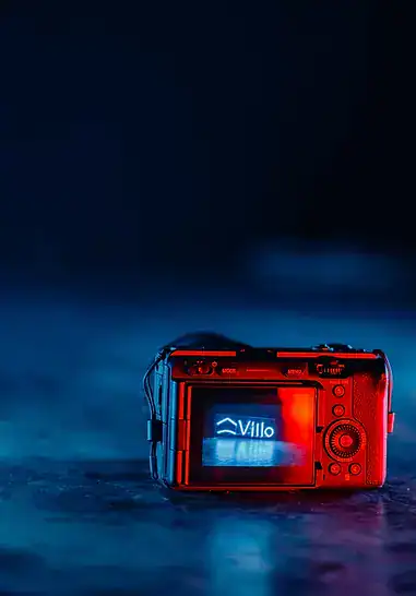 Red camera with Villo Studio branding on a dark background.