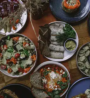 Assorted fresh vegetable salads and sushi platters at Villo Studio, South Africa.