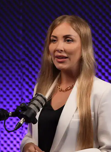 Professional woman speaking into a microphone at Villo Studio podcast recording.