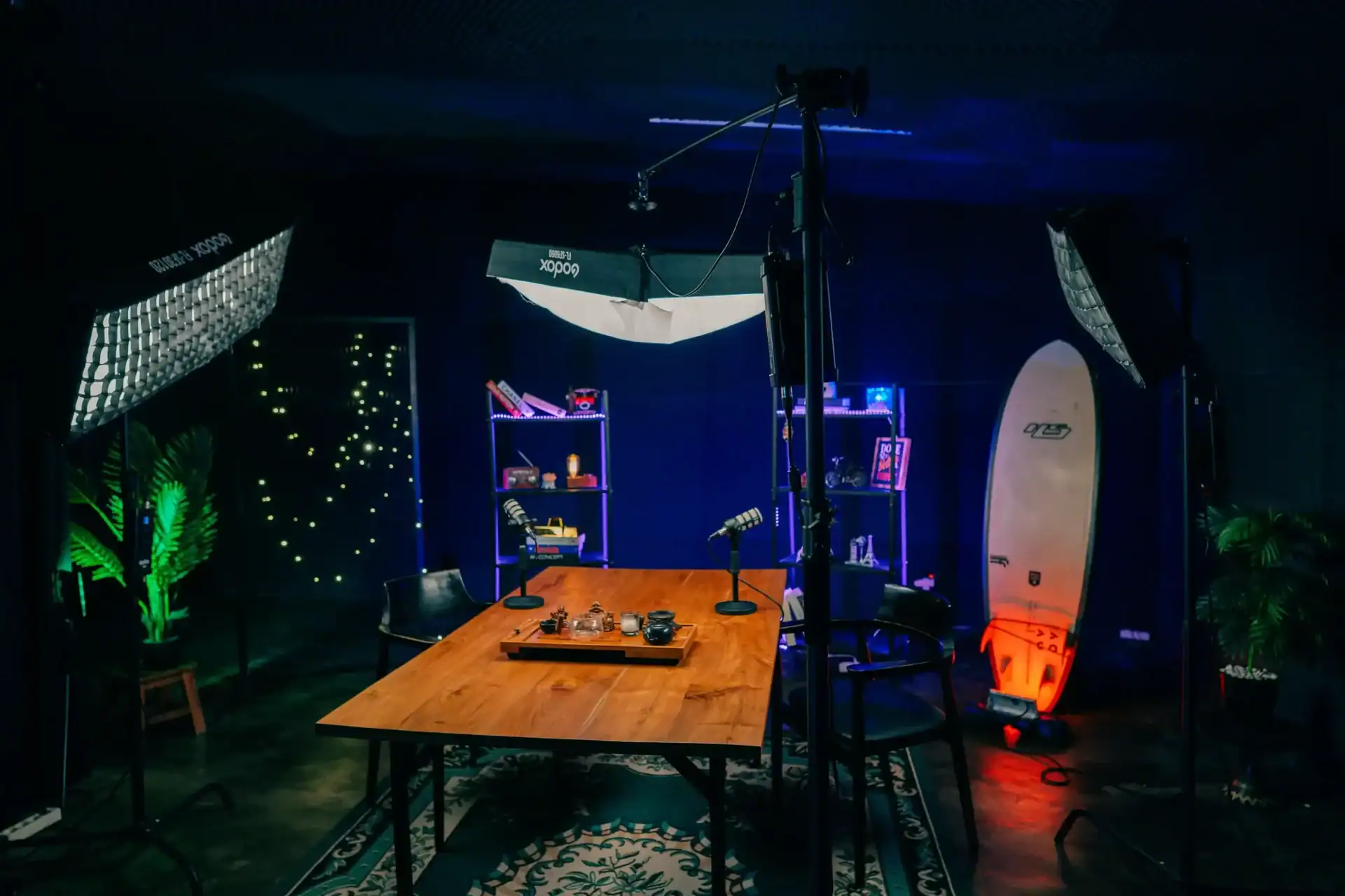 Professional podcast studio setup with lighting, microphones, and creative decor.