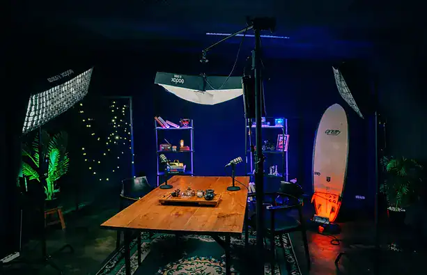 Creative podcast recording studio setup with professional lighting and equipment.