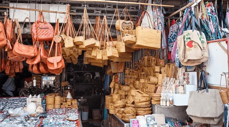 Colourful handmade leather and straw accessories at Villo Studio South Africa market stall.