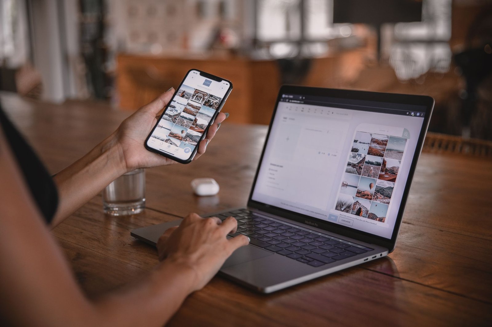 Social media manager planning an Instagram content grid on phone and laptop